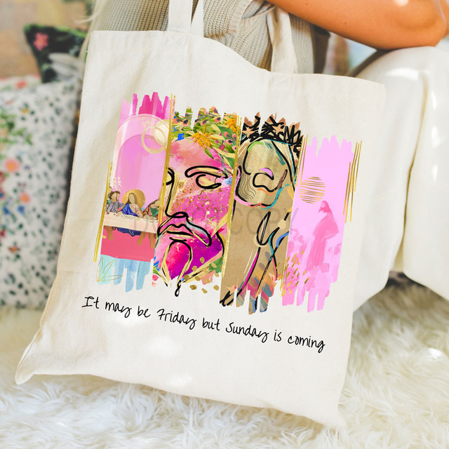 Painted It May Be Friday But Sunday Is Coming DTF Heat Transfer, colorful tote bag with artistic religious design and handwritten quote.