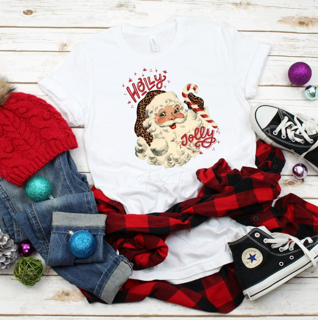 Holly Jolly Vintage Leopard Santa Sublimation Transfer, white T-shirt with vintage Santa face wearing a leopard print hat and a candy cane, holiday festive design.