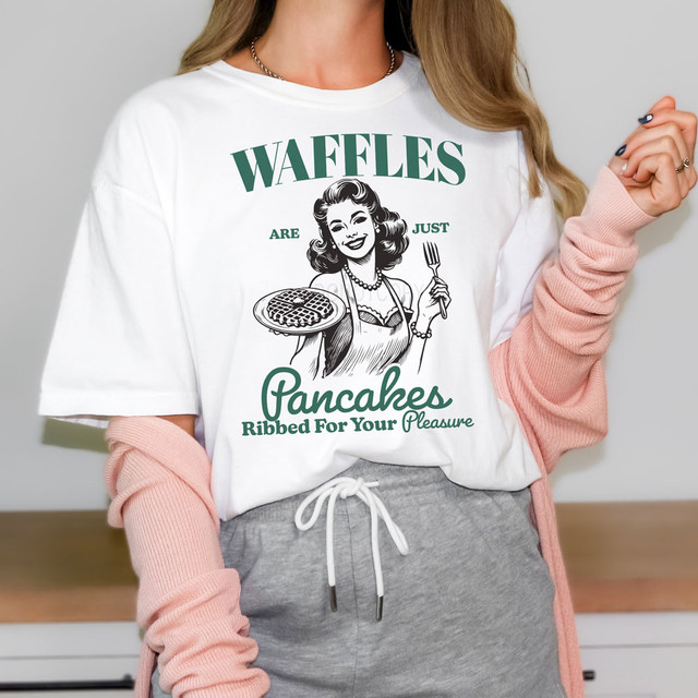 Waffles Are Just Pancakes Ribbed For Your Pleasure DTF Heat Transfer, graphic t-shirt featuring a retro-style woman holding a waffle and fork, with bold text and playful design.