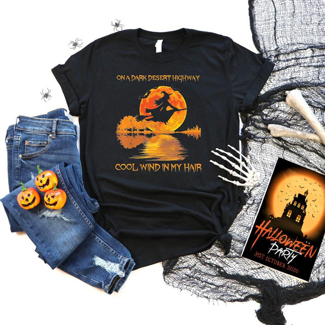 Dark Desert Highway Witch Screen Print Heat Transfer, Halloween themed black T-shirt with witch flying on a broomstick against a full moon with trees and water reflection
