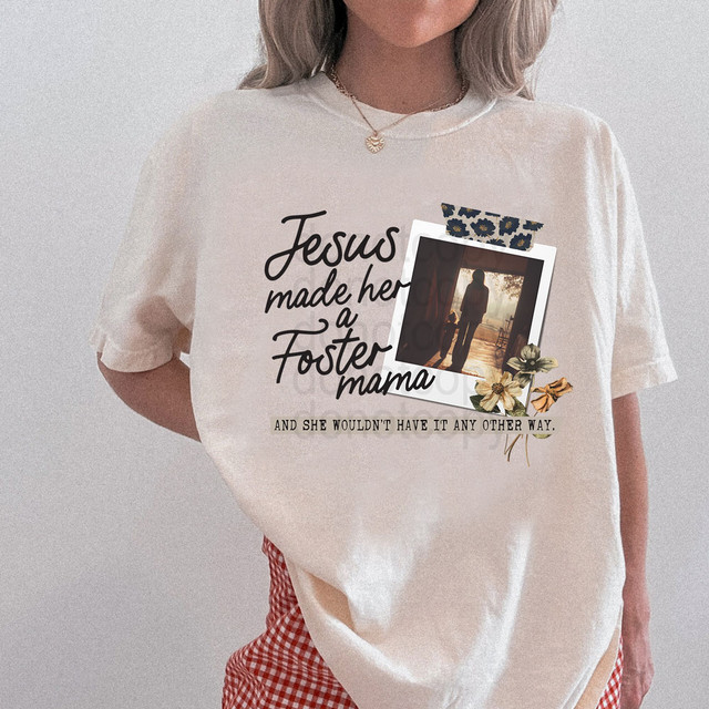 Jesus Made Her A Foster Mom DTF Heat Transfer, a woman wearing a beige T-shirt with a customized design featuring a printed photo, floral accents, and the text 'Jesus made her a Foster mama' and 'and she wouldn't have it any other way'.