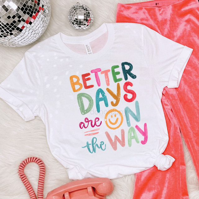 Better Days Are On The Way Happy Face DTF Heat Transfer, colorful and vibrant design on a white T-shirt with pink velvet pants and related accessories.