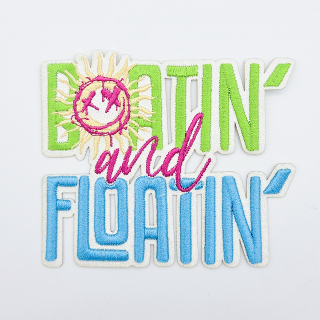 Boatin' and Floatin' LARGE Embroidered HAT/POCKET Patch, colorful embroidered patch with a smiling sun and the words 'BOATIN' and 'FLOATIN'' in green and blue, pink 'and' in the center.