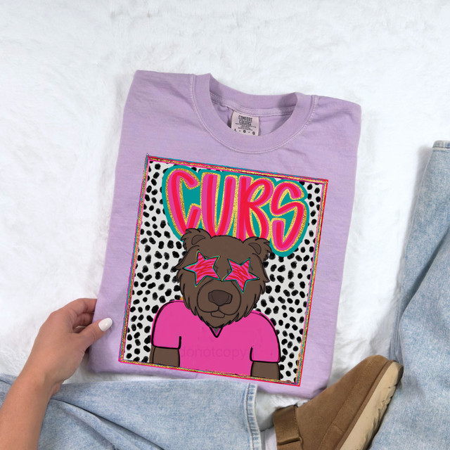 Cubs Colorful Mascot DTF Heat Transfer, vibrant and playful colorful graphic design of a bear mascot wearing star-shaped sunglasses on a lavender t-shirt.