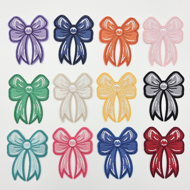 Coquette Bow Embroidered HAT/POCKET Patch, colorful embroidered bow patches in purple, navy, orange, pink, green, beige, yellow, black, turquoise, hot pink, royal blue, and red, with detailed white stitching.