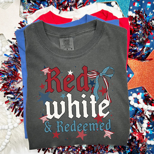 Red, White & Redeemed DTF Heat Transfer, a patriotic-themed design with red, white, and blue stars, and a bow, on a gray t-shirt.