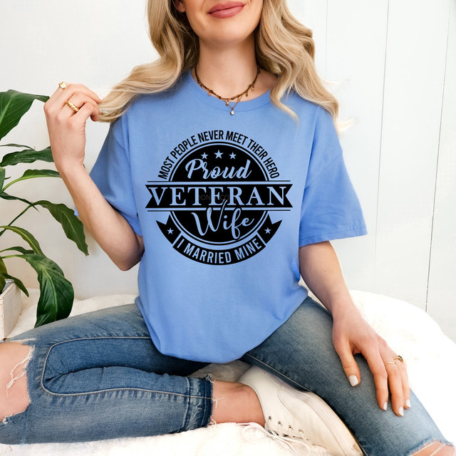 Most People Never Meet Their Heroes I Married Mine DTF Heat Transfer, a woman wearing a blue T-shirt with this printed design.