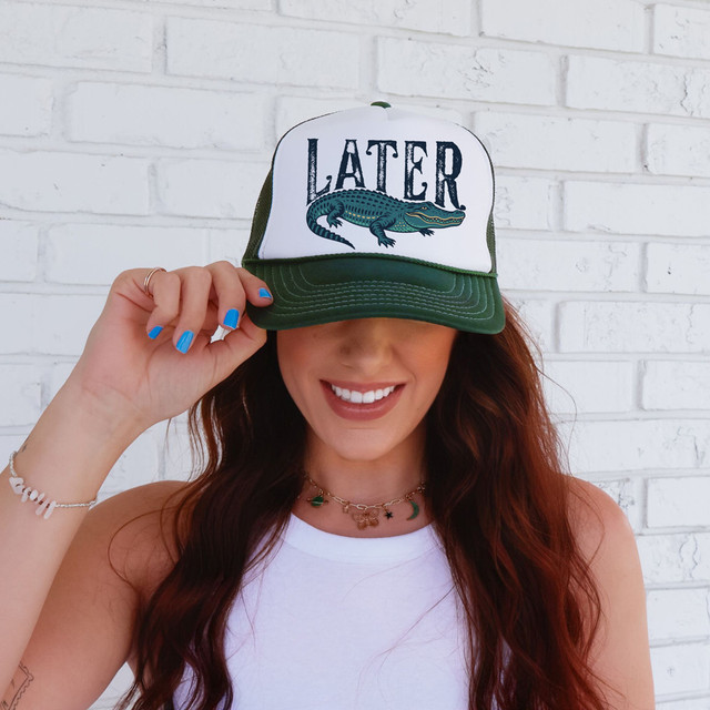 Distressed Later Gator DTF Heat Transfer, woman wearing baseball cap with crocodile graphic and distressed text design.