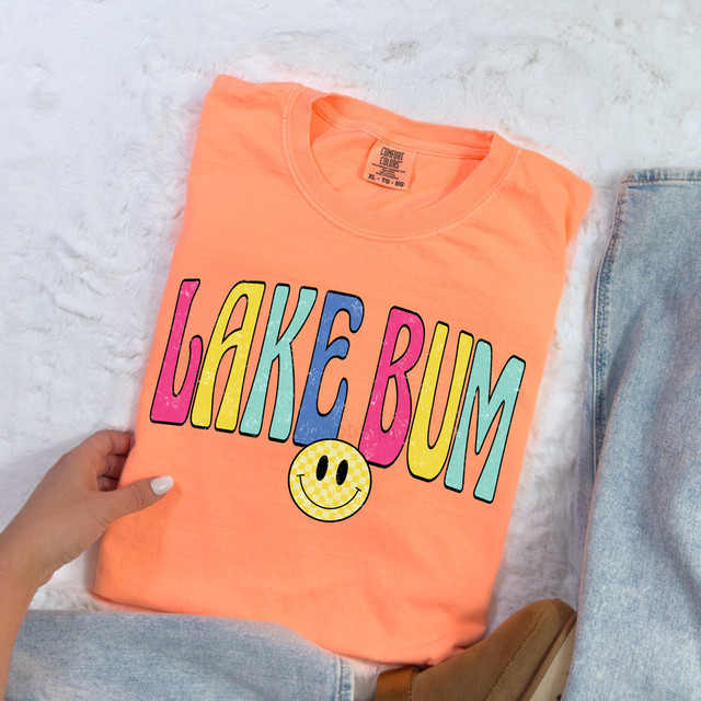 Lake Bum Happy Face DTF Heat Transfer, colorful graphic design on peach-colored T-shirt with smiley face logo.