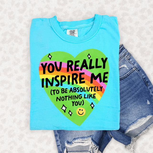 You Really Inspire Me (To Be Absolutely Nothing Like You) DTF Heat Transfer, colorful printed t-shirt with a rainbow heart design and positive message.