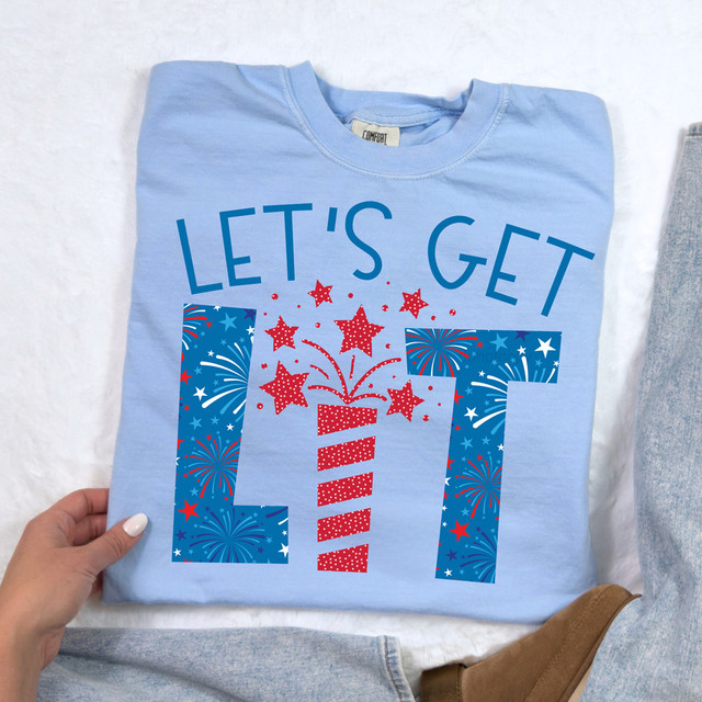 Let's Get Lit Firework Fourth Of July Patriotic DTF Heat Transfer, light blue T-shirt with red, white, and blue fireworks and star design celebrating Independence Day.