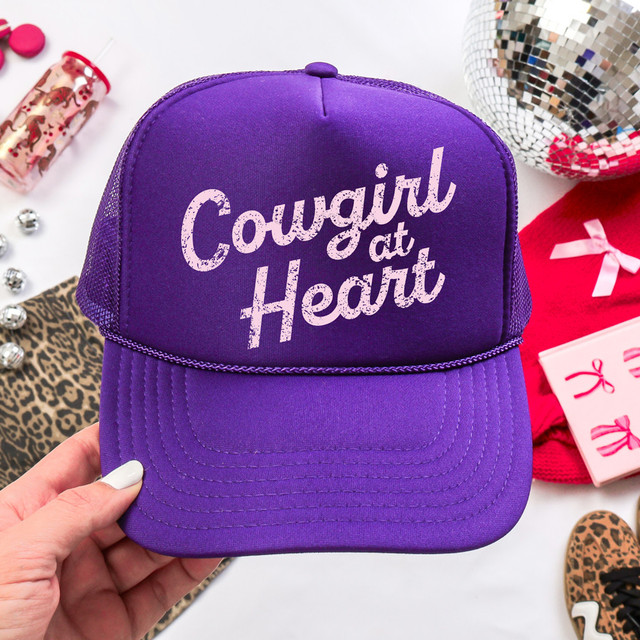 Distressed Cowgirl At Heart DTF Heat Transfer, purple baseball cap with distressed white text saying 'Cowgirl at Heart' on front.