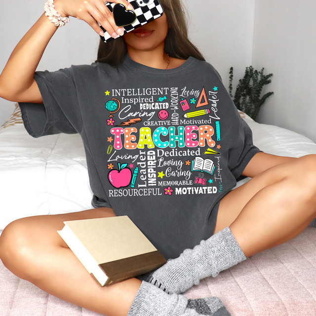 Teacher Word Art DTF Heat Transfer, colorful teacher-themed design with words and icons on a dark gray T-shirt.