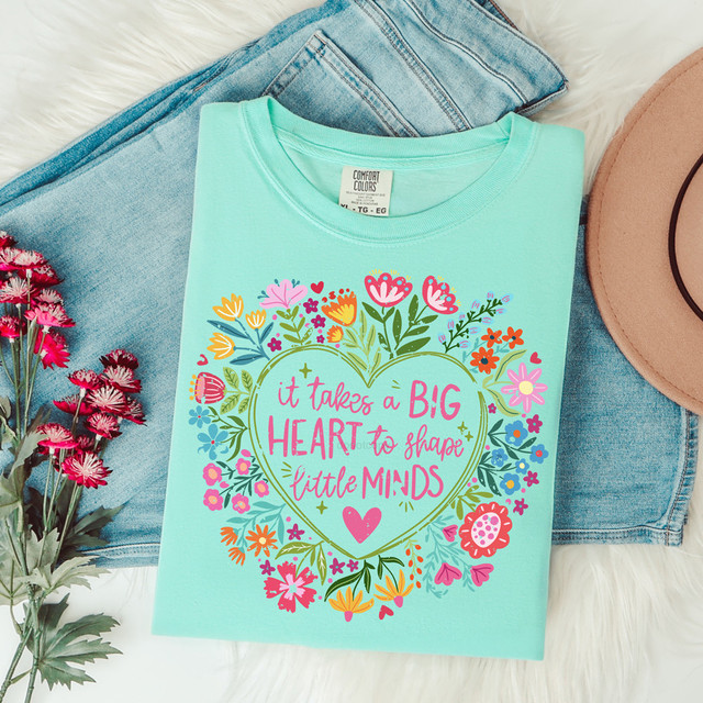 It Takes A Big Heart To Shape Little Minds Heart Floral DTF Heat Transfer, colorful floral design with the quote, on a mint green T-shirt.
