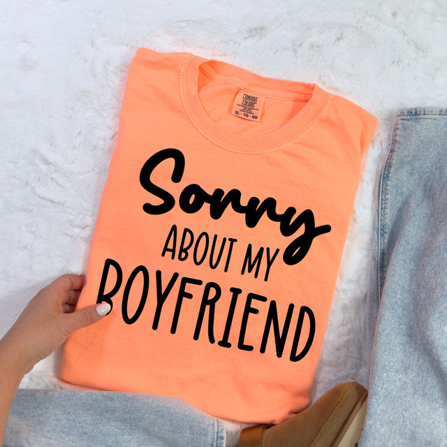 Sorry About My Boyfriend DTF Heat Transfer, peach-colored T-shirt with black handwritten-style text.