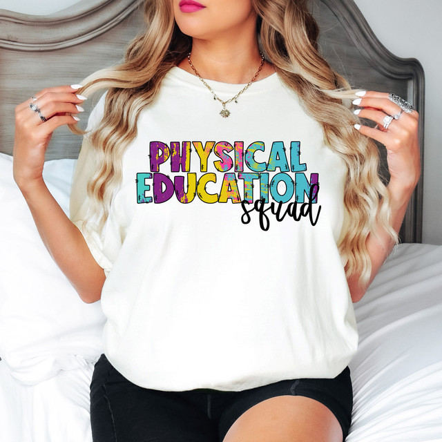 Physical Education Squad DTF Heat Transfer, colorful and playful graphic design on a white T-shirt worn by a woman with long blonde hair.