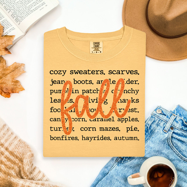 Faux Glitter Fall Words DTF Heat Transfer, orange glitter script letter 'fall' on a beige t-shirt with fall-themed words.