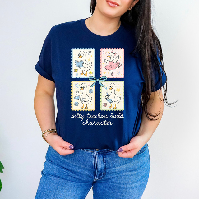 Silly Teachers Build Character Bow DTF Heat Transfer, graphic illustration of four cartoon swans dressed as teachers and students, with the text "silly teachers build character" on a navy blue t-shirt.