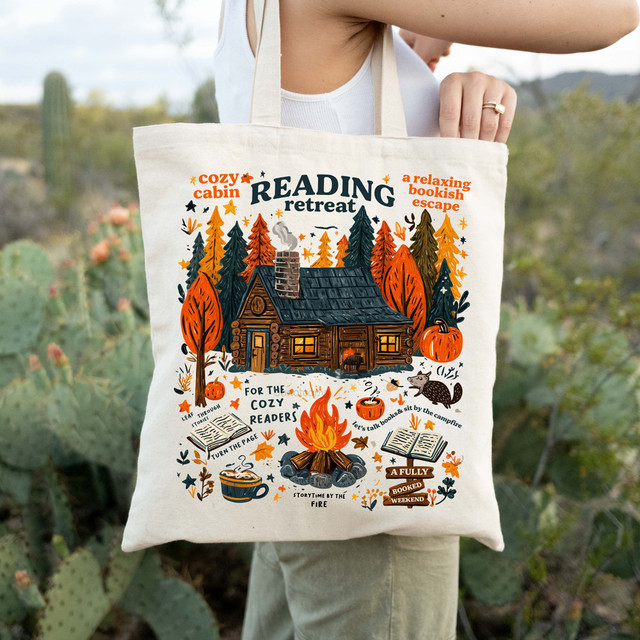 Cozy Cabin Reading Retreat DTF Heat Transfer, image of a tote bag with a cozy cabin and autumn elements dedicated to reading and relaxation.