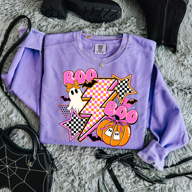Retro Boo Lightning DTF Heat Transfer, vibrant Halloween-themed design on a purple sweatshirt featuring pumpkins, ghosts, stars, and lightning bolts.
