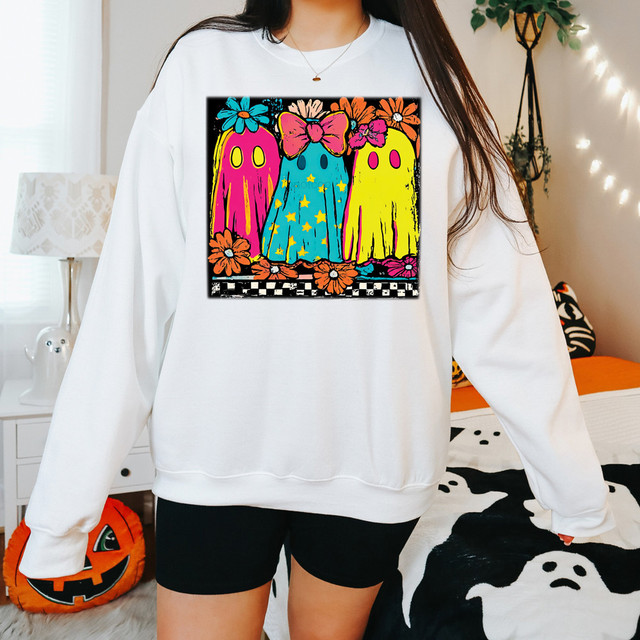 Bright Ghosts DTF Heat Transfer, colorful graphic of three ghost characters with flowers and stars on a white sweatshirt.
