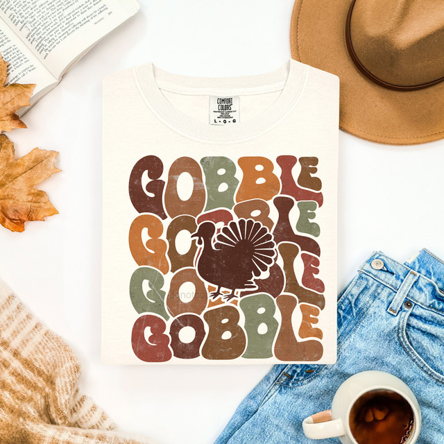 Stacked Gobble Retro DTF Heat Transfer, a colorful vintage-style graphic of a turkey with the words 'GOBBLE GOBBLE' in bold retro font displayed on a white T-shirt.