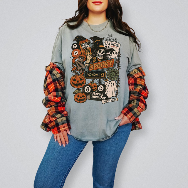 Spooky Have A Nice Day DTF Heat Transfer, Halloween-themed graphic design on a grey sweatshirt featuring pumpkins, a ghost, skull, witch hat, and spooky phrases.