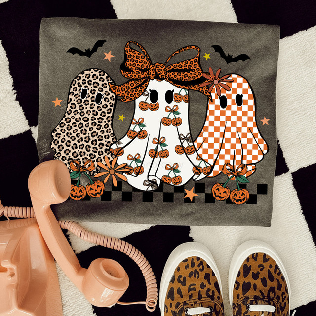 Patterned Ghost Trio DTF Heat Transfer, Halloween-themed design featuring three ghost characters with animal print and checkered patterns, decorated with pumpkins, bows, and bats.