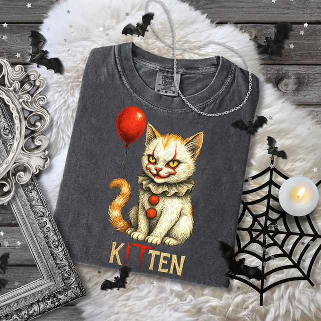 Kitten IT DTF Heat Transfer, Halloween-themed graphic of a grinning cat with clown makeup, a red balloon, and the word 'KITTEN' on a gray T-shirt.
