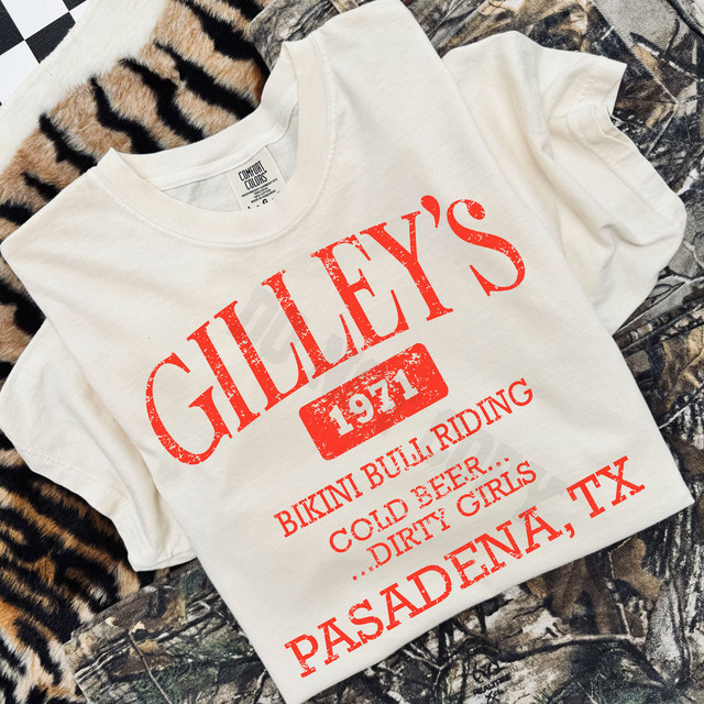 Gilley's Bikini Bull Riding DTF Heat Transfer, white t-shirt with red distressed print design for a vintage look, featuring bold text and graphics inspired by western and rodeo themes.