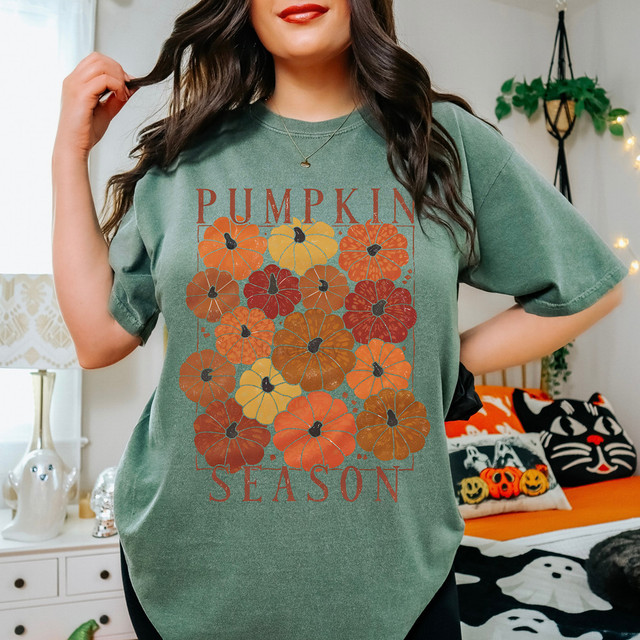 Rustic Pumpkin Season DTF Heat Transfer, a decorative design featuring colorful pumpkins in autumn colors on a green t-shirt.