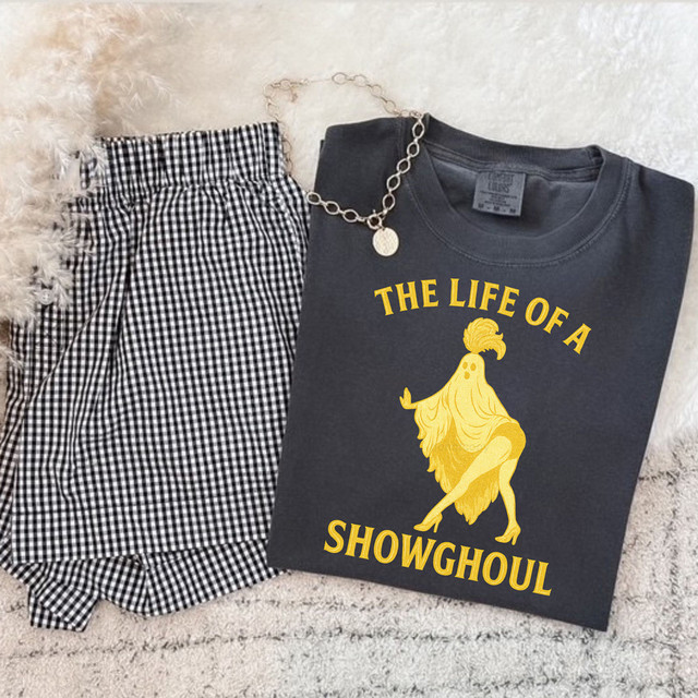 The Life Of A Showghoul DTF Heat Transfer, a yellow graphic of a rooster with a feminine stance on a dark gray T-shirt.