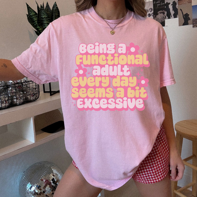 Being A Functional Adult Every Day Seems A Bit Excessive Retro DTF Heat Transfer T-Shirt, pink graphic tee with playful text design.