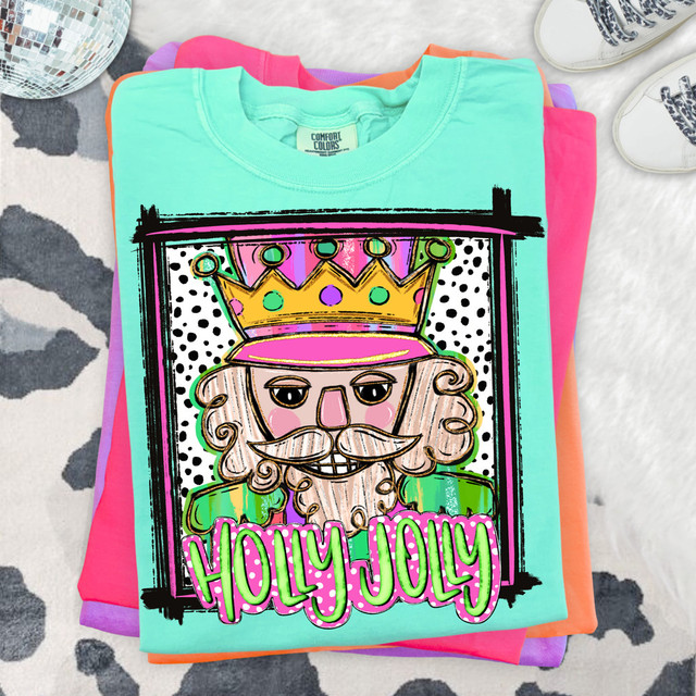 Whimsical Holly Jolly Nutcracker DTF Heat Transfer, colorful illustrated nutcracker with a crown and mustache, with the text Holly Jolly in pink and green, for Christmas-themed apparel.