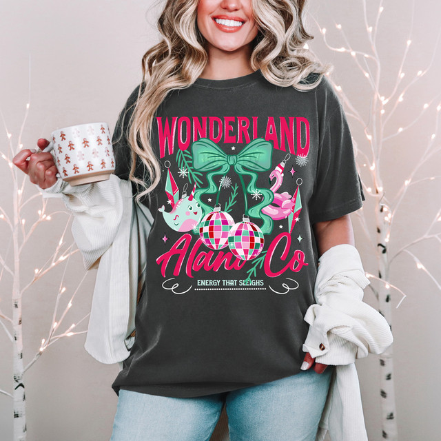 Wonderland Alani Co DTF Heat Transfer, colorful holiday-themed design on a black T-shirt featuring ornaments, a bow, and decorative elements.
