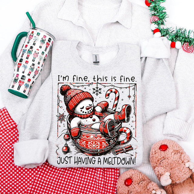 I'm Fine Snowman DTF Heat Transfer, humorous Christmas-themed graphic on a grey sweatshirt featuring a snowman relaxing in a cup with holiday decorations.