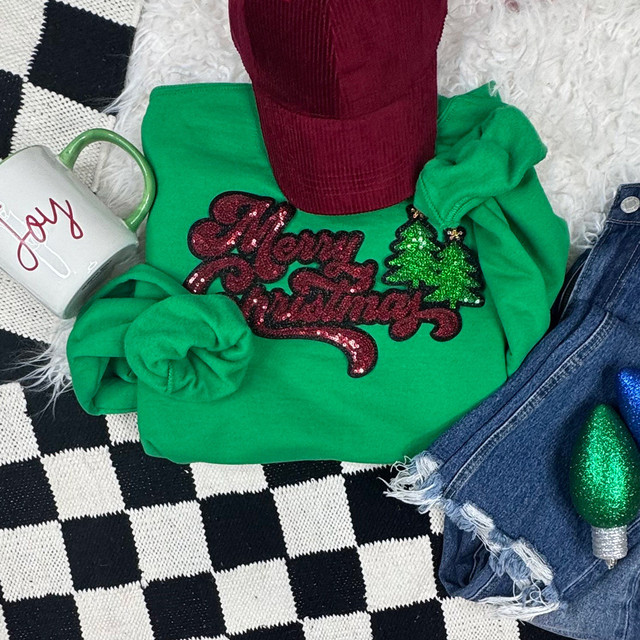 Sparkly Merry Christmas Sequins Patch, festive holiday themed patch with green and red sequins and Christmas tree design on a green sweatshirt.
