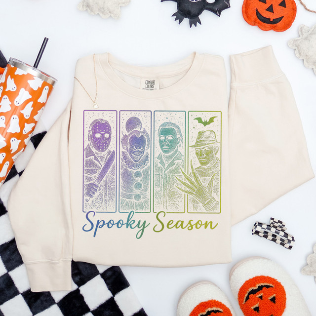 Spooky Season Horror DTF Heat Transfer, Halloween-themed design on a cream sweatshirt featuring four spooky characters and the text 'Spooky Season' in colorful fonts.