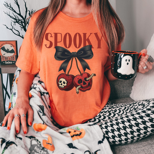 Spooky Cherries DTF Heat Transfer, orange t-shirt with spooky cherry design featuring skull and monster faces with a black bow.