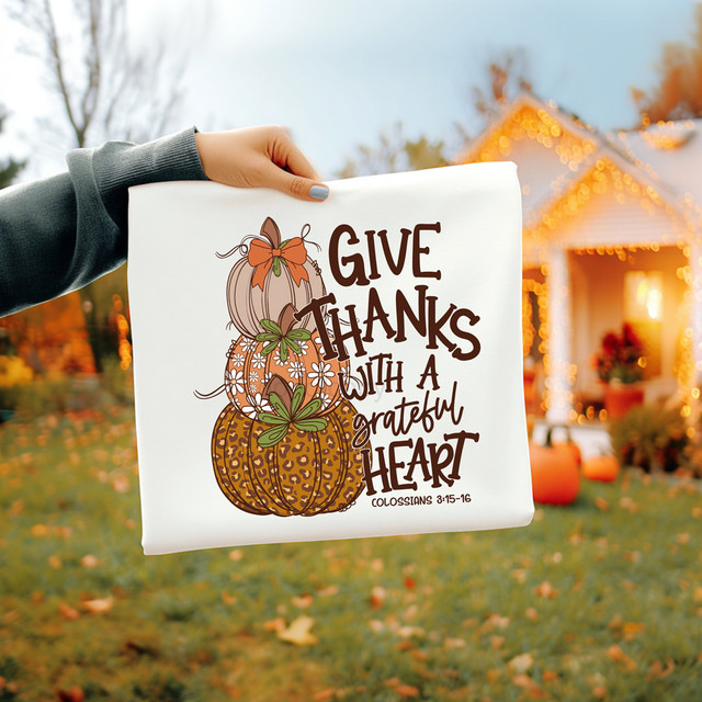 Give Thanks With A Grateful Heart Patterned Pumpkins DTF Heat Transfer, a fall-themed design featuring stacked pumpkins with decorative patterns and bows, and the text "Give Thanks With A Grateful Heart" from Colossians 3:15-16.