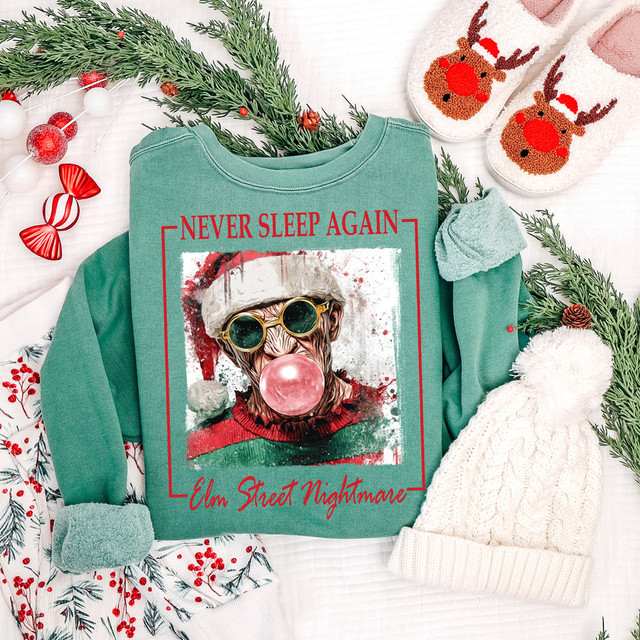 Never Sleep Again DTF Heat Transfer, Christmas themed sweatshirt with a graphic of a dog wearing sunglasses and a Santa hat, with text 'Never Sleep Again' and 'Elm Street Nightmare'.