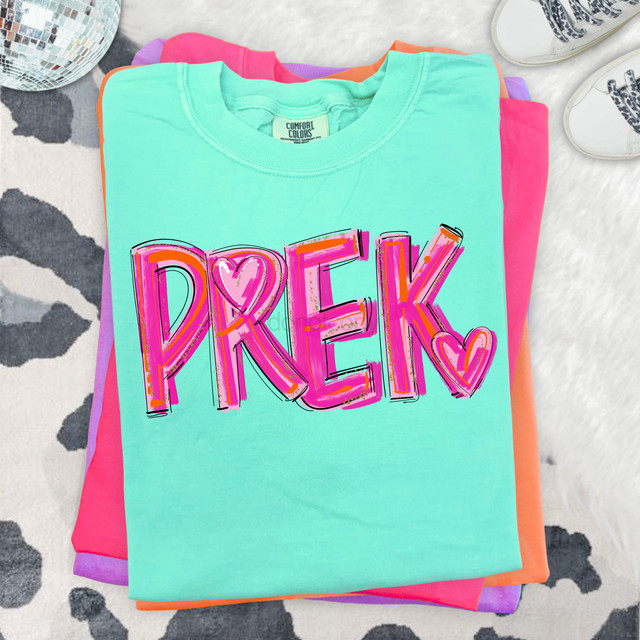 PreK Heart Painted DTF Heat Transfer, colorful shirt with the word 'PREK' and heart designs in pink and purple on a teal background.