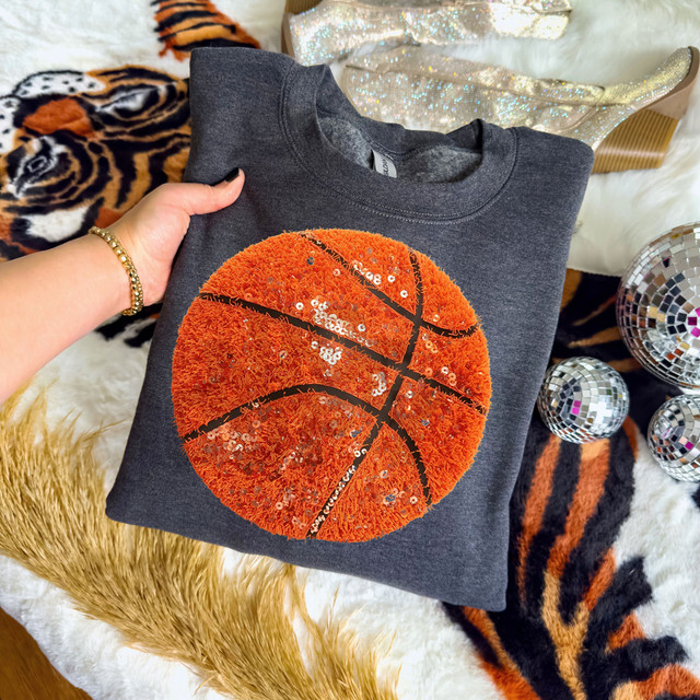 Faux Yarn And Sequin Basketball DTF Heat Transfer, orange and black sequined basketball design applied to a dark gray sweatshirt.