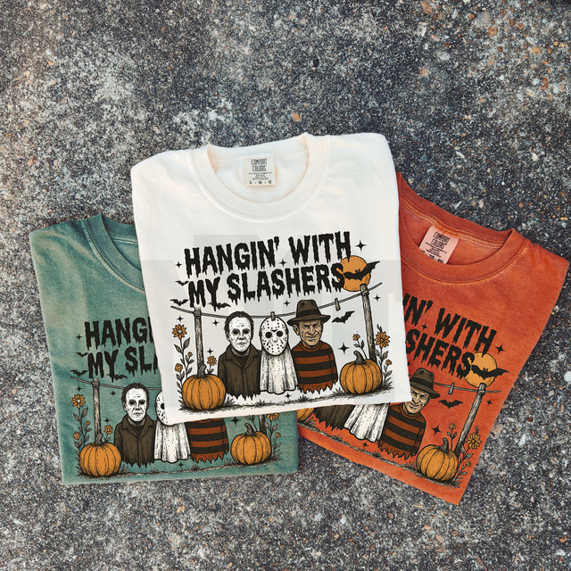 Hangin' With My Slashers DTF Heat Transfer, Halloween-themed graphic design on three T-shirts featuring iconic slasher movie characters with pumpkins and bats.