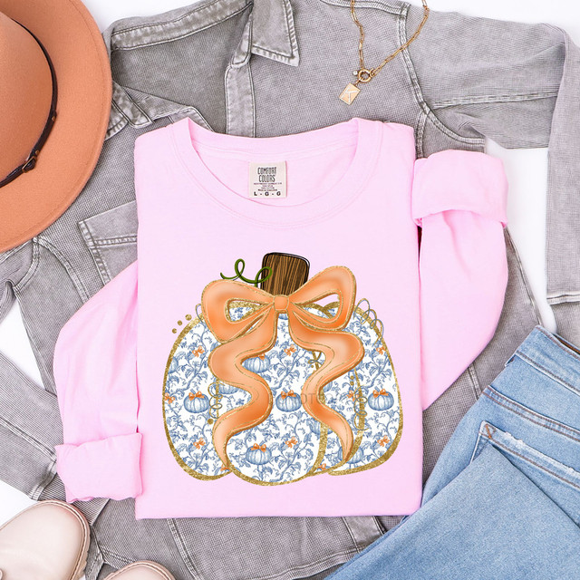 Blue Pattern Pumpkin Orange Bow DTF Heat Transfer, festive pumpkin design with an orange bow on a pink t-shirt.