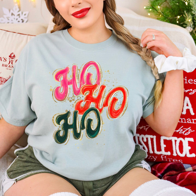 Ho Ho Ho Brushstroke DTF Heat Transfer, colorful festive Christmas heat transfer design on a woman's t-shirt.