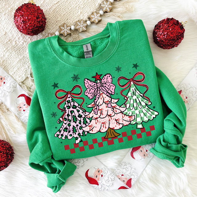 Bow Tree Trio DTF Heat Transfer, colorful Christmas tree design on a green sweatshirt with holiday decorations around it.