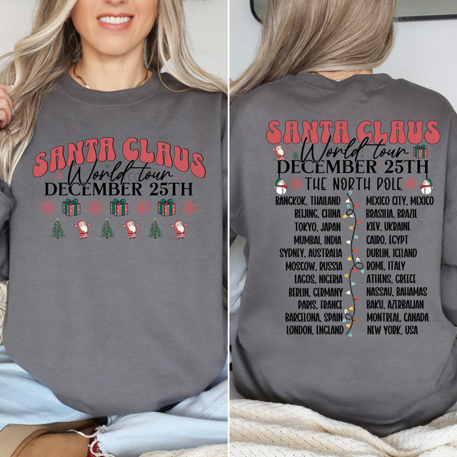 Santa Claus World Tour FULL SET DTF Heat Transfer, gray sweatshirt featuring Christmas-themed design with Santa, gifts, trees, and a list of international cities for December 25th celebration.
