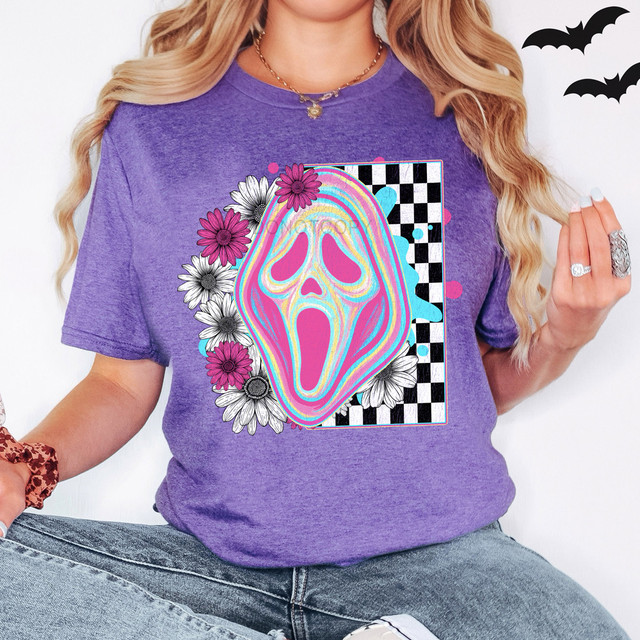 GhostFace Distressed Floral DTF Heat Transfer, vibrant colorful ghost face design surrounded by black and white daisies and pink flowers on purple T-shirt.