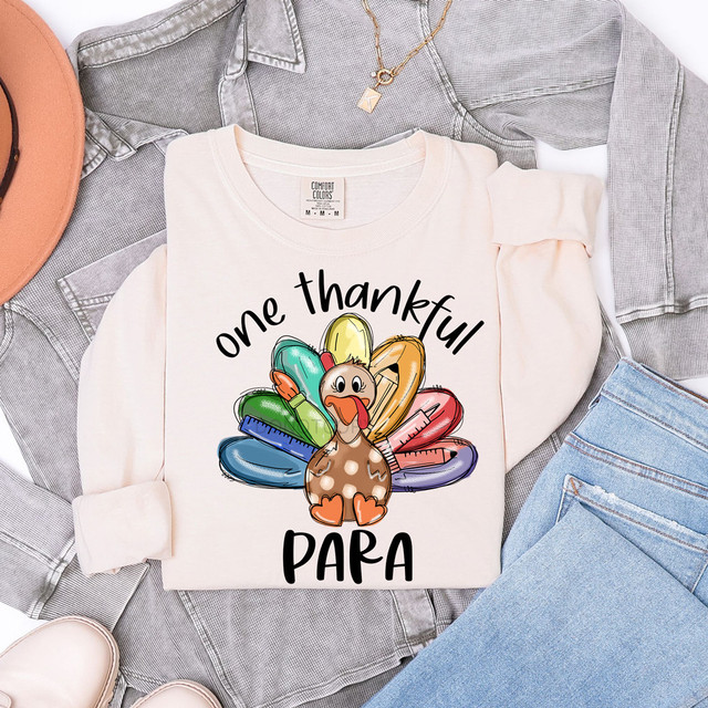 One Thankful Para DTF Heat Transfer, colorful cartoon turkey with measuring tools and the text 'one thankful PARA' on a white sweatshirt.